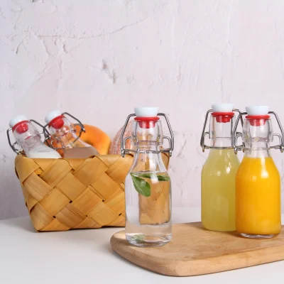 Clear Round 4 oz Small Glass Flip Top Bottles for Vinegar Beverage