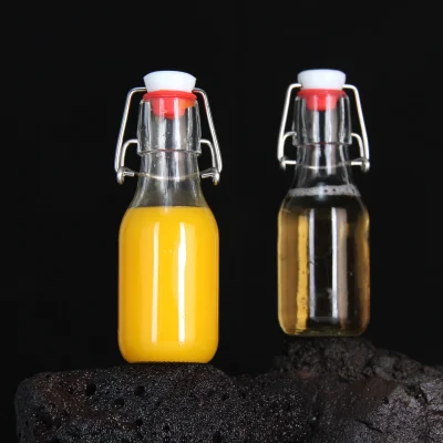 Clear Round 4 oz Small Glass Flip Top Bottles for Vinegar Beverage